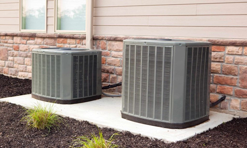 outside central air conditioning system units sitting next to each other