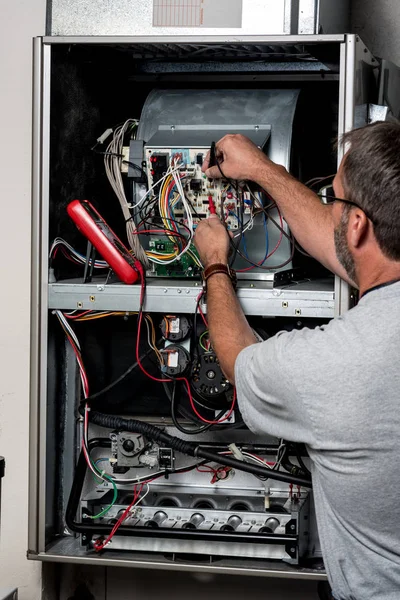 an HVAC technician diagnosing a furnace repair issue